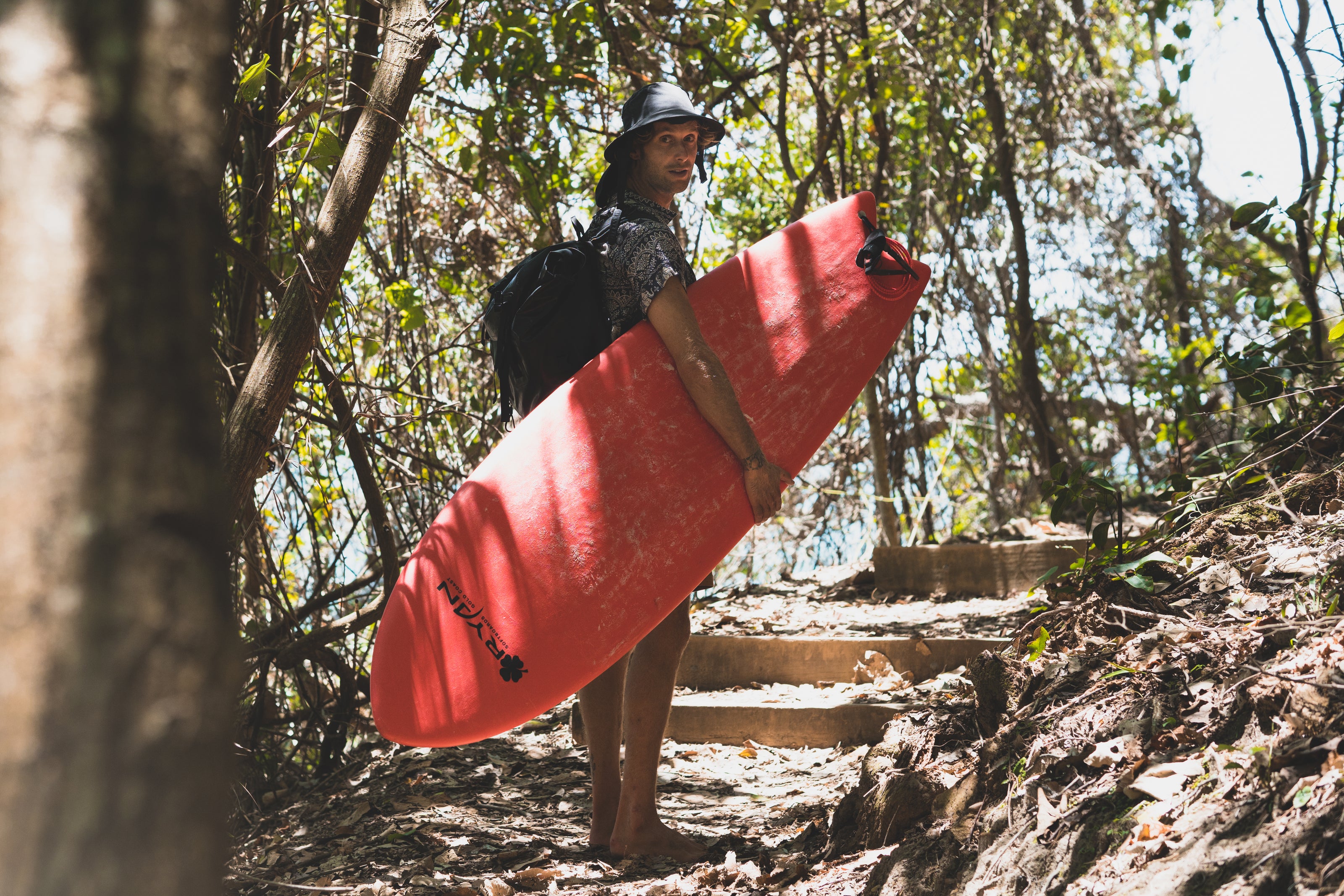 A Surfer in Australia walking to the beach with his quality Ryan Softboard Surfboard